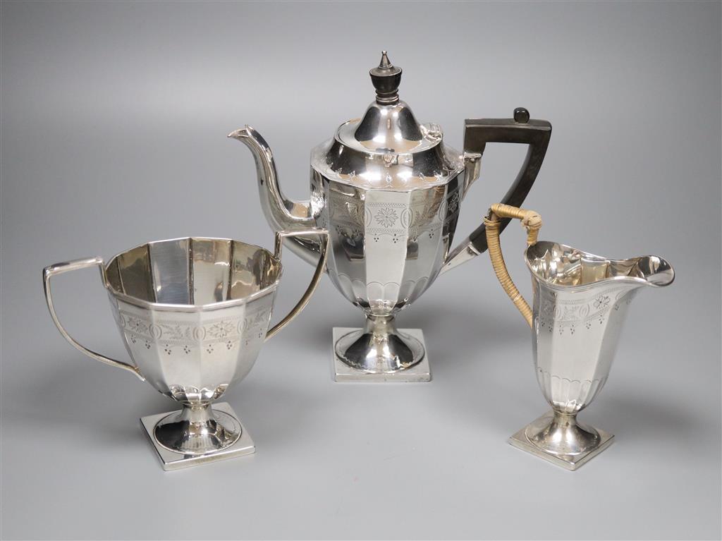 An Edwardian engraved silver three piece pedestal coffee set by James Deakin & Sons, Sheffield, 1904,